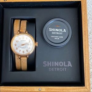 Woman’s rose gold Shinola watch thin beige strap